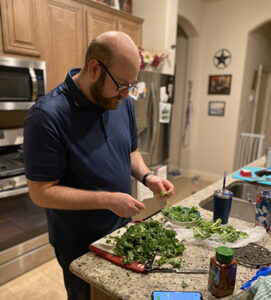 Adoptive dad cooking in kitchen