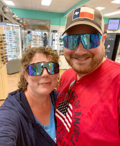 Adoptive parents in silly 80's sunglasses for selfie