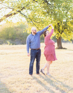 Adoptive parents dance in field